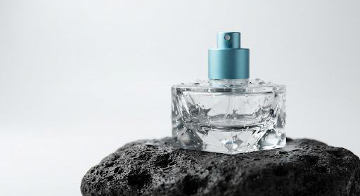 Glass cosmetic bottle on a volcanic slate pedestal